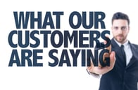 Business man pointing the text What Our Customers Are Saying
