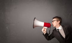 Guy shouting into megaphone on copy space background