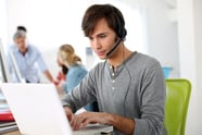 Student with headset on doing English language test